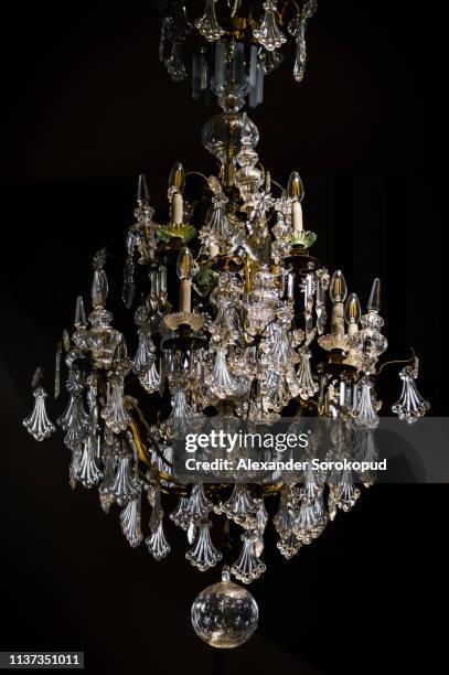 majestic old crystal luster on black background - chandelier stock pictures, royalty-free photos & images