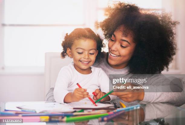 african american young mother with daughter drawing together - baby paint stock pictures, royalty-free photos & images