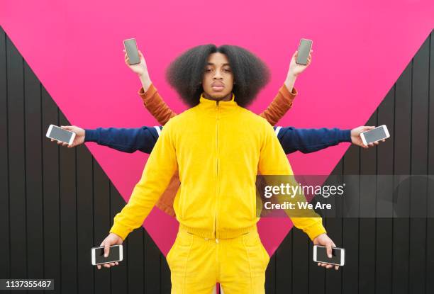 multiple people holding phones out at arms length - multiple screens stockfoto's en -beelden