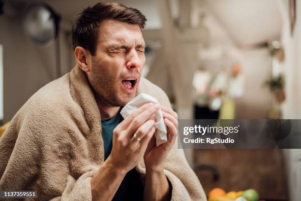 ill man sneezing - sneezing stock pictures, royalty-free photos & images