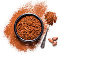 Cocoa powder with cocoa beans shot from above on white background