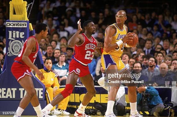 Kareem Abdul-Jabbar of the Los Angeles Lakers holds the ball in the post during an NBA game against the Philadelphia 76ers at the Great Western Forum...
