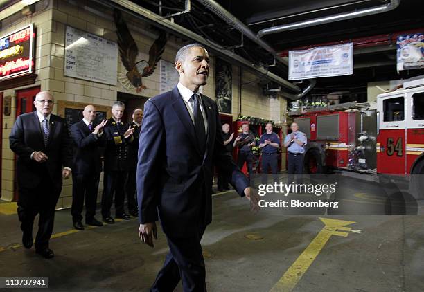 Rudy Giuliani, former mayor of New York, left, follows U.S. President Barack Obama during a visit to firefighters at the headquarters of Engine...