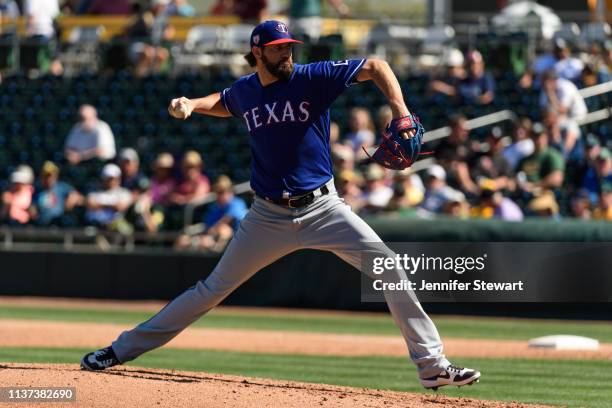 Jason Hammel of the Texas Rangers delivers a pitch during the spring training game against the Oakland Athletics at HoHoKam Stadium on March 05, 2019...