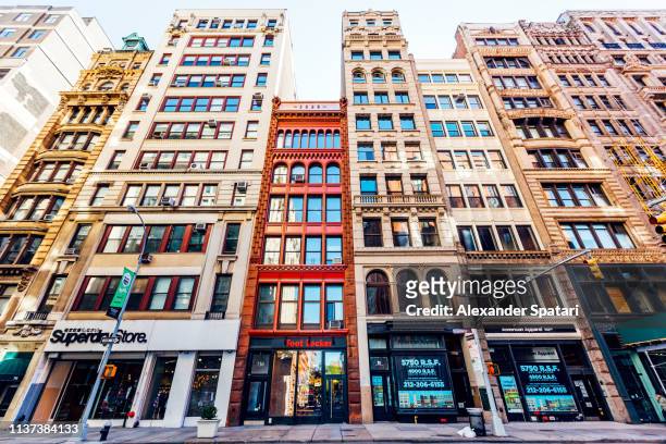 low angle view of residential houses and shops in tribeca, new york city, usa - shopping center stock-fotos und bilder