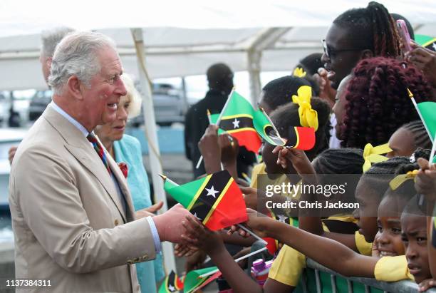 Prince Charles, Prince of Wales and Camilla, Duchess of Cornwall are greeted by children on March 21, 2019 in Nevis, St Kitts, Saint Kitts and Nevis....