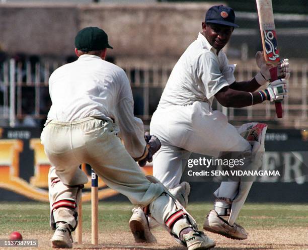 Sri Lankan batsman Sanath Jayasuriya swipes the ball past the Zimbabwe wicket keeper G. Flower 17 January on the fourth day of their second and final...