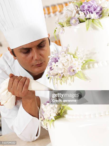 chef decorating a wedding cake - piping cream stock pictures, royalty-free photos & images