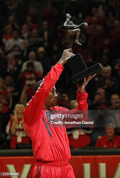 Derrick Rose of the Chicago Bulls holds up the Maurice Podoloff Trophy awarded to the NBA Most Valuable Player before taking on the Atlanta Hawks in...