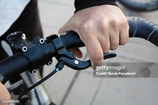 hand on bike handle and brake - bike handle stock pictures, royalty-free photos & images