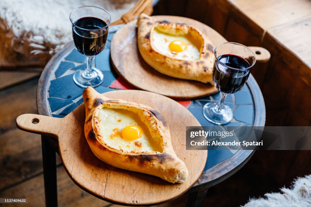 Khachapuri served with red wine in a restaurant