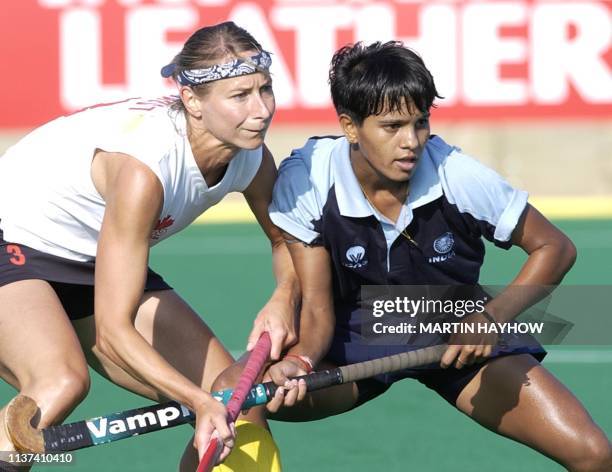 Canada's Lisa Faust and India's Saba Anjum in a dual for the ball during their first round match at Belle Vue Stadium, Manchester 26 July 2002, on...