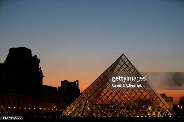 The Louvre Pyramid is seen at sunset on March 21, 2019 in Paris, France. The pyramid of the Louvre Museum celebrates its 30th anniversary. Designed...