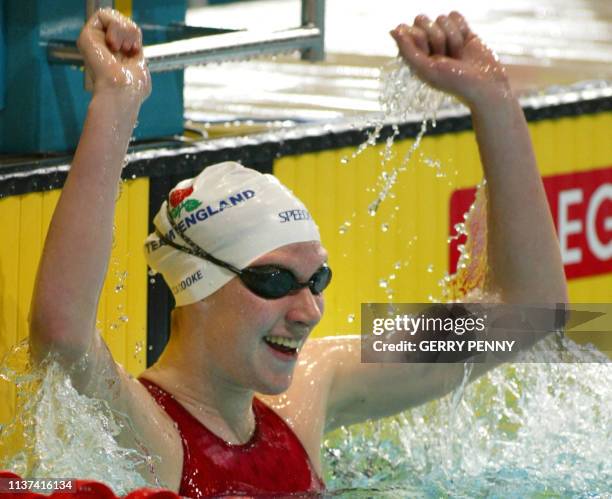 England's Rebecca Cooke celebrates after winning the 2002 Manchester Commonwealth Games women's 400m freestyle finals 03 August 2002. AFP PHOTO GERRY...