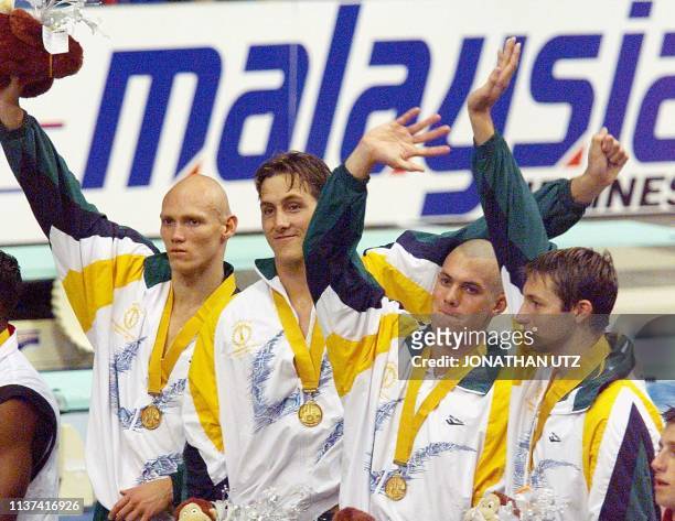 Australia's 4X100M Freestyle Relay team wave after receiving their gold medals Michael Klim, Chris Fydler, Ashley Callus and Ian Thorpe 15 September...