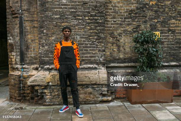 generation-z black male fashionista in modern street style clothing in london, uk - street style men stock pictures, royalty-free photos & images
