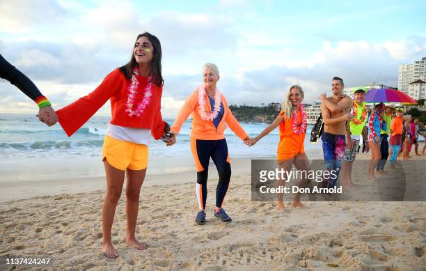 Dr Kerryn Phelps links hands with surfers on the Bondi Beach shoreline on March 22, 2019 in Sydney, Australia. Surfers gather to celebrate five years...