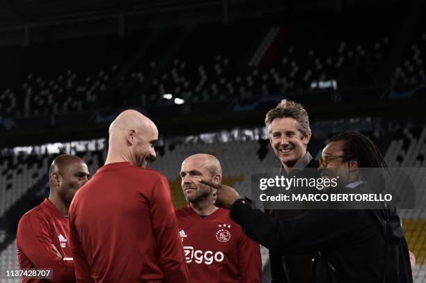 Ajax's Dutch coach Erik Ten Hag talks with Dutch former professional footballers Edgar Davids and Edwin van der Sar during a training session on...