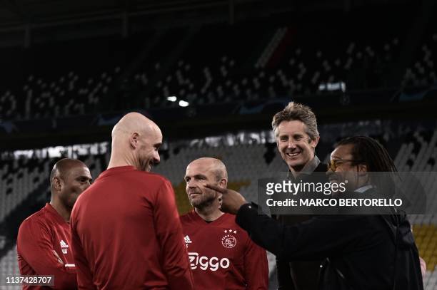 Ajax's Dutch coach Erik Ten Hag talks with Dutch former professional footballers Edgar Davids and Edwin van der Sar during a training session on...
