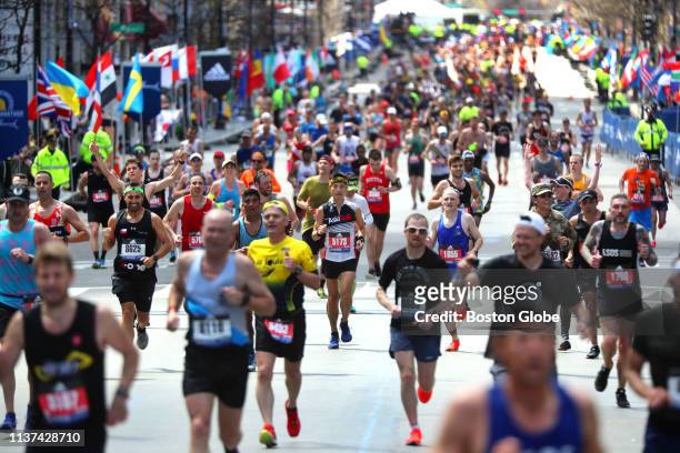 Runners head to the finish line on Boylston Street in Boston during the 123rd Boston Marathon on April 15, 2019.
