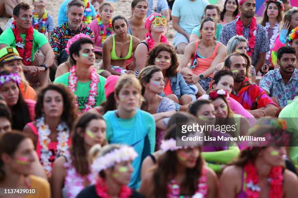 Crowds dress in bright colours in solidarity with OneWave at sunrise on Bondi Beach on March 22, 2019 in Sydney, Australia. Surfers gather to...