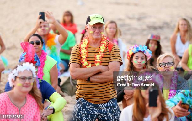 People look on solemnly as One Wave founder Grant Treblico addresses the crowd on March 22, 2019 in Sydney, Australia. Surfers gather to celebrate...