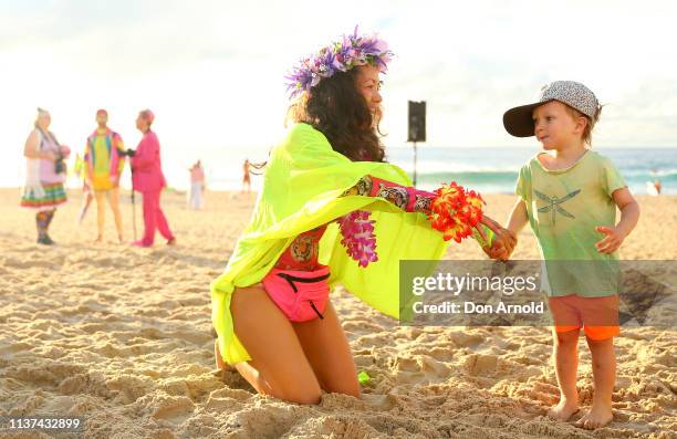 Young boy dances alongside his mother on March 22, 2019 in Sydney, Australia. Surfers gather to celebrate five years of OneWave, a not for profit...