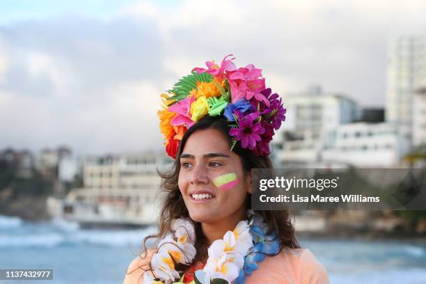 Surfer wears flowers in her hair in solidarity with OneWave at sunrise on Bondi Beach on March 22, 2019 in Sydney, Australia. Surfers gather to...