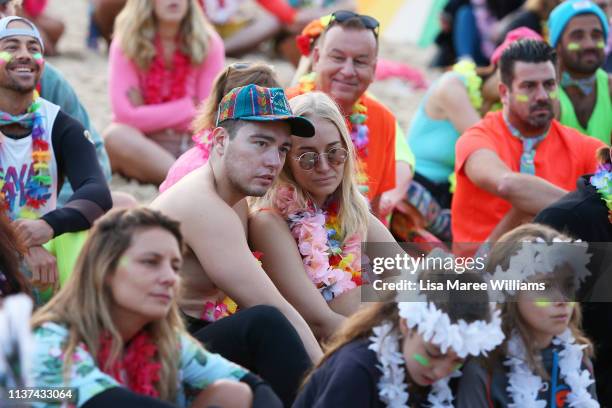 Crowds dress in colour in solidarity with OneWave at sunrise on Bondi Beach on March 22, 2019 in Sydney, Australia. Surfers gather to celebrate five...