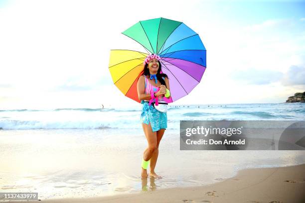 Fluro clad Jodi Hooker poses on the Bondi Beach shoreline on March 22, 2019 in Sydney, Australia. Surfers gather to celebrate five years of OneWave,...