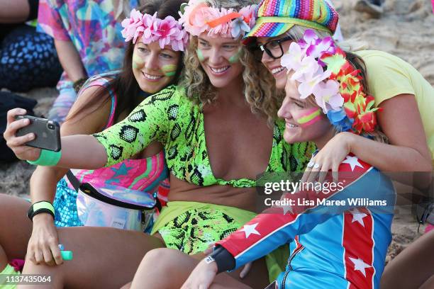 Ladies dress in bright colours in solidarity with OneWave at sunrise on Bondi Beach on March 22, 2019 in Sydney, Australia. Surfers gather to...