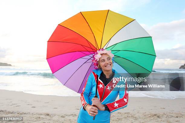 Young surfer wears bright clothes and flowers in her hair in solidarity with OneWave at Bondi Beach on March 22, 2019 in Sydney, Australia. Surfers...