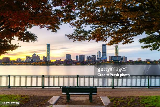 boston skyline in autumn viewed from across the river in massachusetts, usa. - boston stock-fotos und bilder