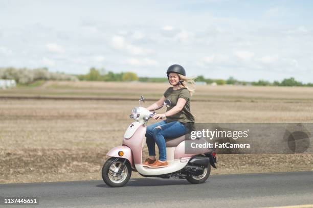 woman riding scooter in country - driver rider stock pictures, royalty-free photos & images