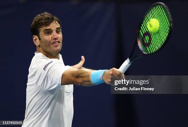 Malek Jaziri of Tunisia returns the ball against Dan Evans of Great Britain during day four of the Miami Open tennis on March 21, 2019 in Miami...