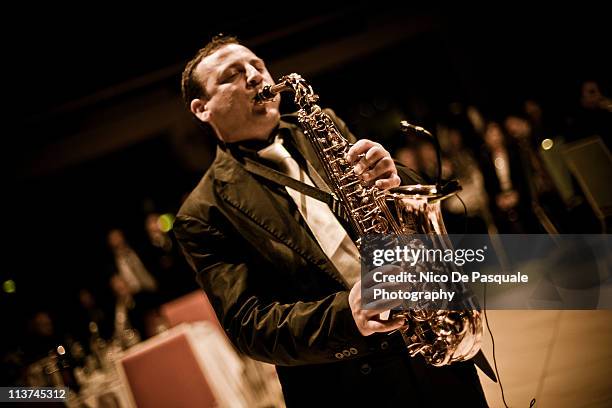 one man playing a saxophone - sassofono foto e immagini stock