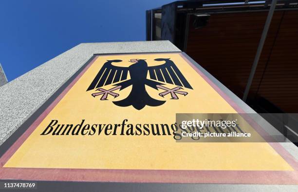 April 2019, Baden-Wuerttemberg, Karlsruhe: A sign with a federal eagle and the words "Bundesverfassungsgericht" , taken before the court in...