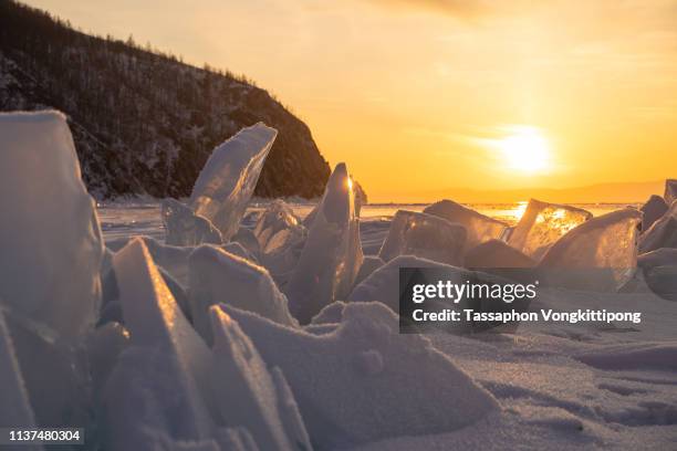 iceberg cracked with sunset from the frozen baikal lake in irkutsk, russia - lake baikal stock pictures, royalty-free photos & images