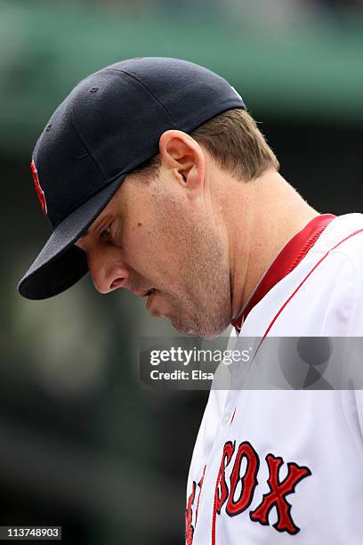 John Lackey of the Boston Red Sox walks into the dugout after he was pulled from the game against the Los Angeles Angels on May 5, 2011 at Fenway...