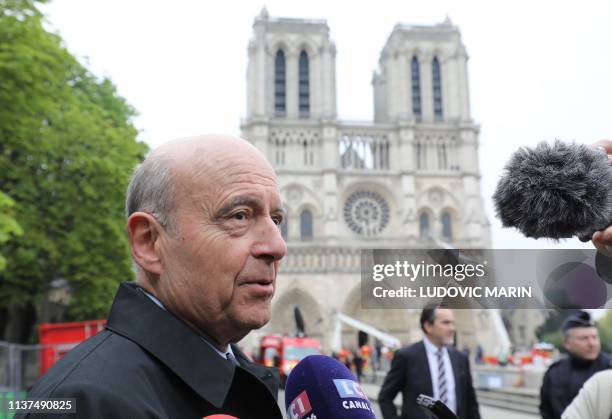 Member of the French Constitutional Council Alain Juppe, speaks to journalists outside Notre-Dame Cathedral in Paris on April 16 in the aftermath of...