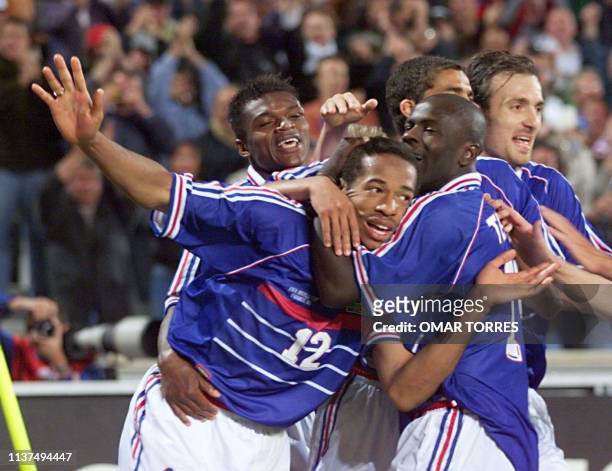 Frenchman Thierry Henry is congratulated by his teammates Marcel Desailly, Lilian Thuram, David Trezeguet and Christophe Dugarry after scoring the...