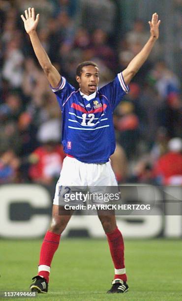 Picture dated late 12 June showing French forward Thierry Henry who scored the third goal for his team celebrating at the Velodrome Stadium in...