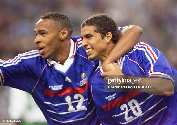 French forward David Trezeguet is greeted by Thierry Henry after he scored the 2nd goal,18 June at the Stade de France in Saint-Denis, during the...