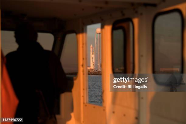 In this NASA handout, a Northrop Grumman Antares rocket carrying a Cygnus resupply spacecraft is seen from a boat at sunrise on Pad-0A April 16, 2019...