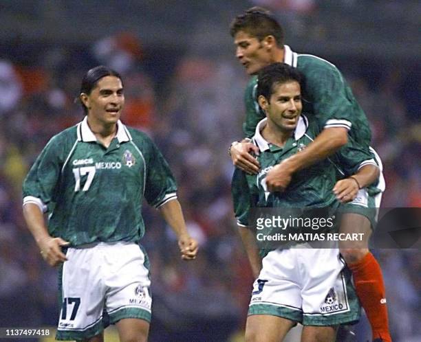 Mexico's Francisco Palencia runs to greet teammates Jose Abundis and Ramon Ramirez after Mexico scored their second goal against Brazil 04 August1999...