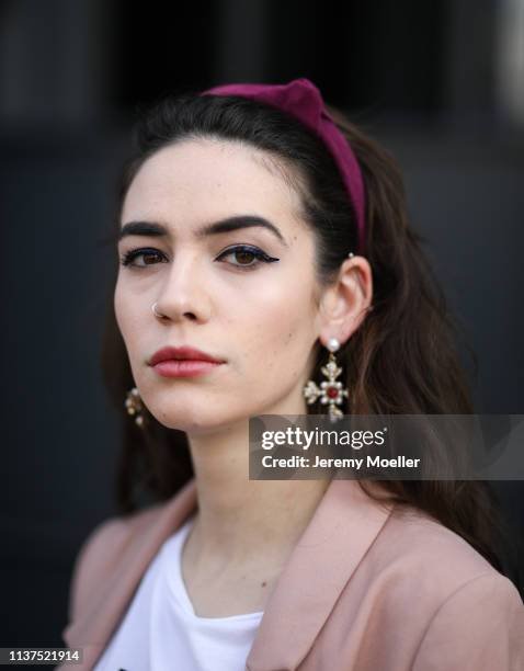 Frankie Miles wearing headband hoop Bordeaux topshop, Statement earrings royal cross pearls Asos on March 20, 2019 in Berlin, Germany.