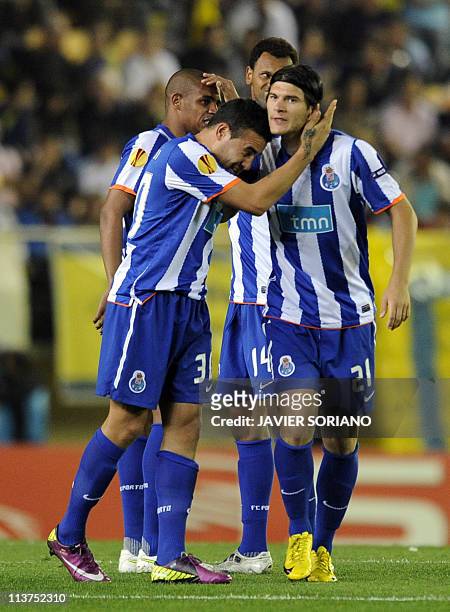 Porto's Romanian defender Cristian Sapunaru and FC Porto's Argentinian defender Nicolas Otamendi celebrate after teammate FC Porto's Colombian...
