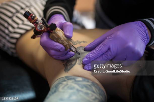 young woman getting a tattoo - butterfly tattoos stock pictures, royalty-free photos & images