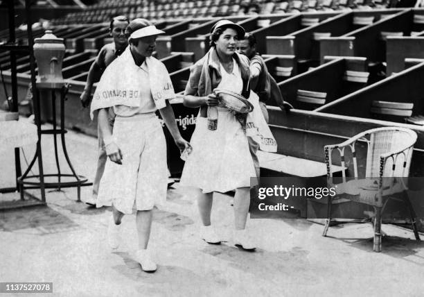 British tennis player Margaret Scriven and German Cilly Aussem enter the Court here in may 1934 at Roland Garros stadium during the French tennis...