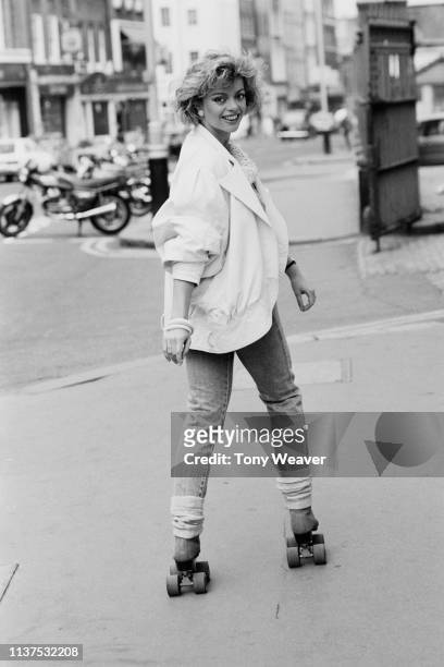 British actress and singer Sarah Payne on roller skates in London, UK, 6th May 1984.